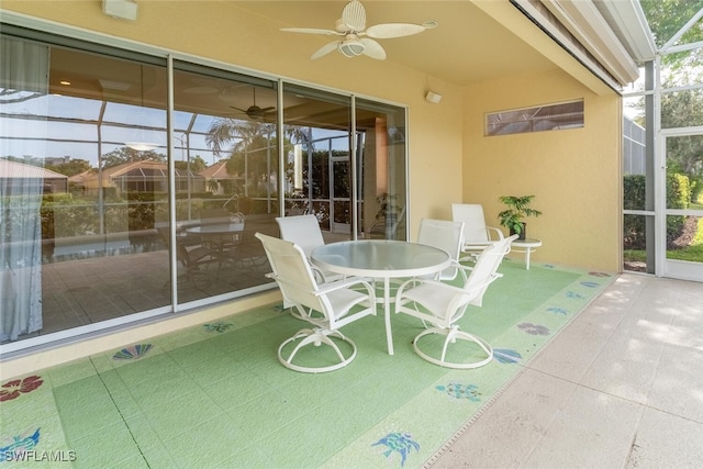 unfurnished sunroom featuring ceiling fan