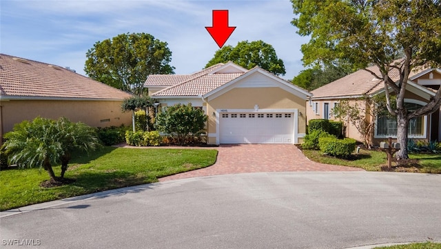 view of front of property with a garage and a front yard