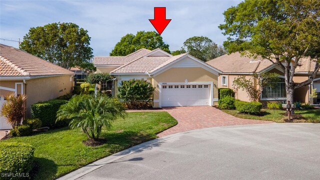 view of front of property with a front lawn and a garage