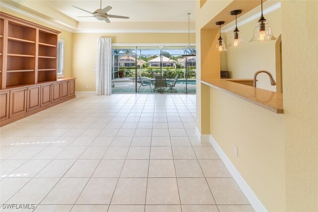 unfurnished living room with ceiling fan, sink, and light tile patterned floors