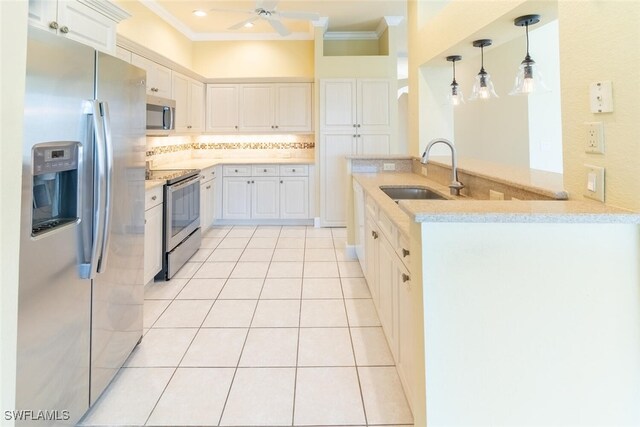 kitchen featuring sink, kitchen peninsula, white cabinets, and stainless steel appliances