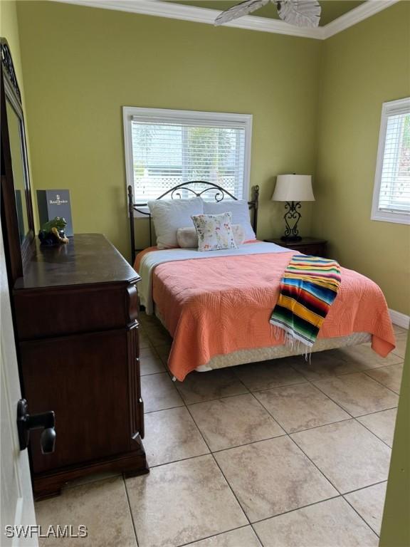 tiled bedroom with ornamental molding