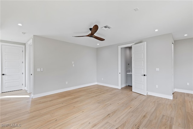 spare room featuring ceiling fan and light hardwood / wood-style flooring