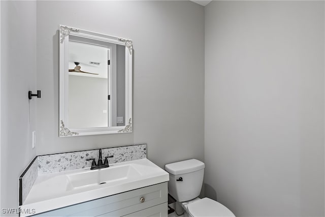 bathroom featuring toilet and vanity