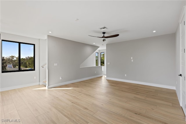 unfurnished room with light wood-type flooring and ceiling fan