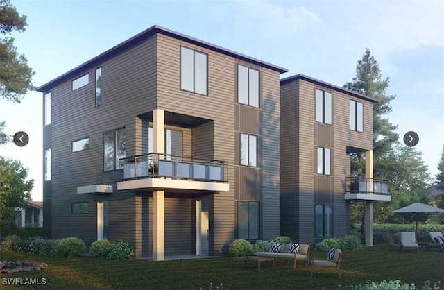 exterior space with a balcony and a front yard