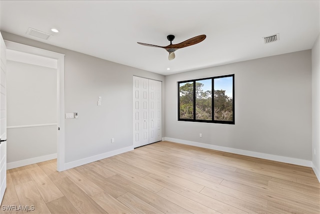 unfurnished bedroom with ceiling fan, light hardwood / wood-style floors, and a closet