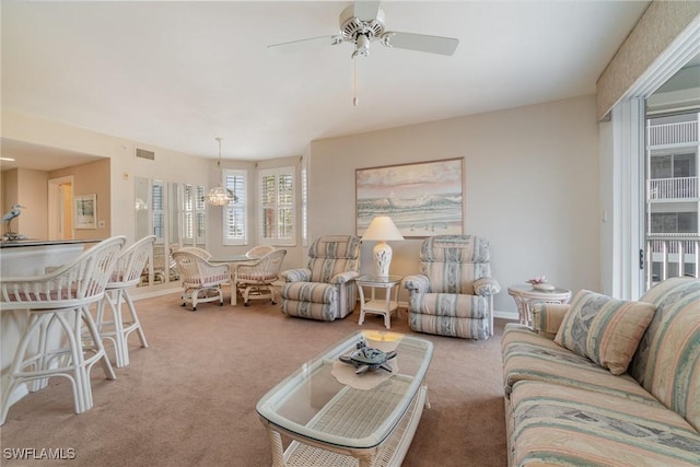 carpeted living room with ceiling fan