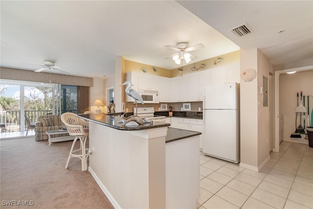 kitchen featuring white cabinetry, light tile patterned floors, white appliances, and ceiling fan