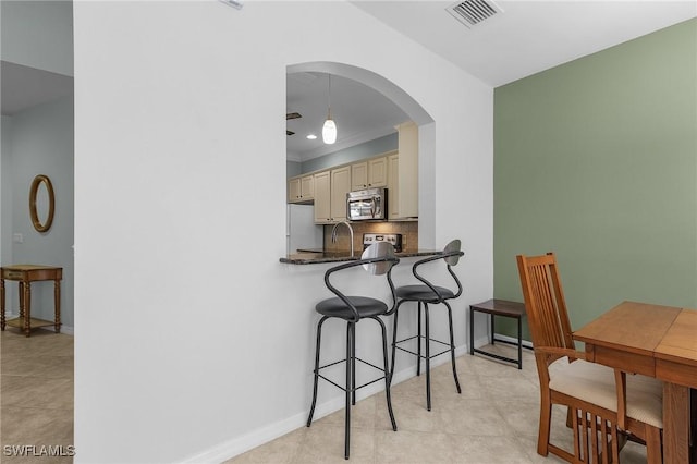 dining space featuring crown molding and sink