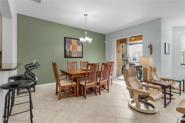 tiled dining area featuring an inviting chandelier