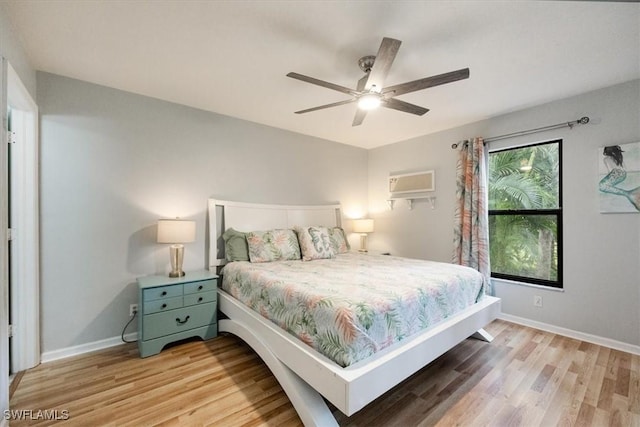 bedroom featuring ceiling fan, baseboards, and wood finished floors