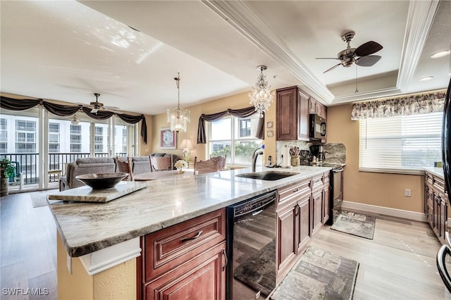 kitchen featuring sink, crown molding, light stone counters, a raised ceiling, and black appliances