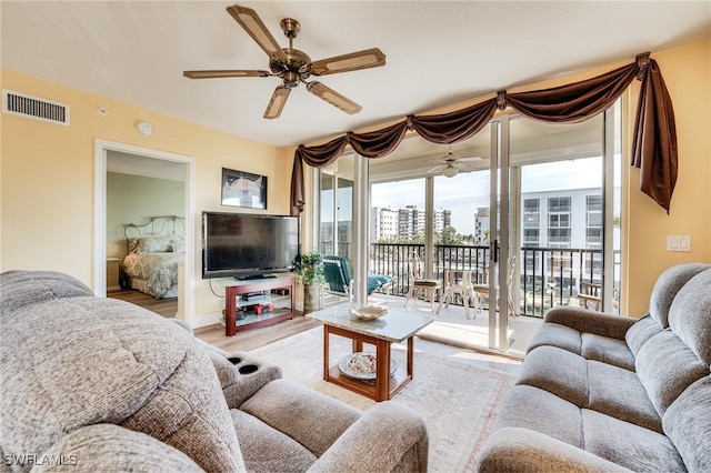 living room featuring hardwood / wood-style flooring and ceiling fan