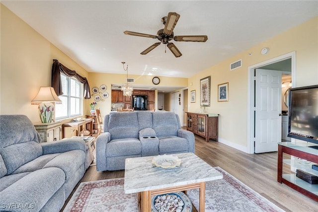 living room with wood-type flooring and ceiling fan