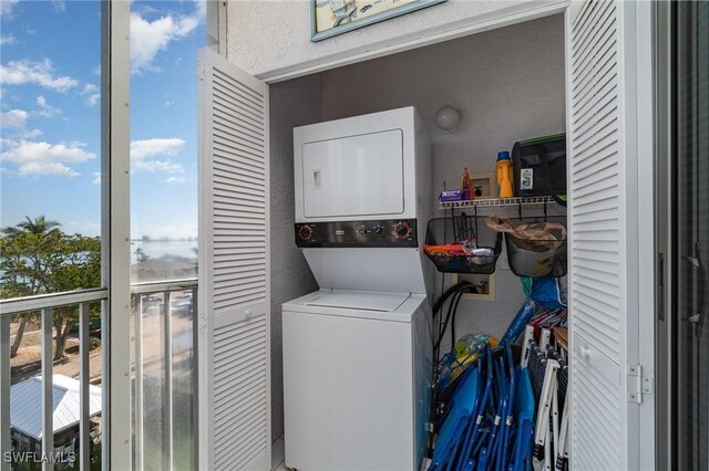 laundry room with stacked washer / drying machine