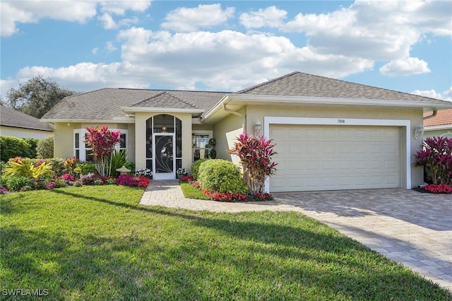 ranch-style house featuring a garage and a front yard