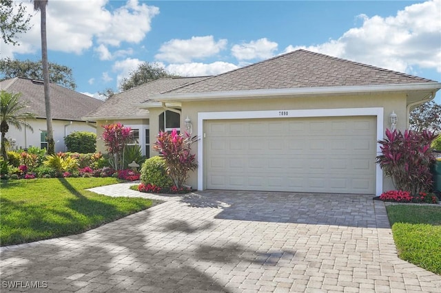 single story home with a garage and a front lawn