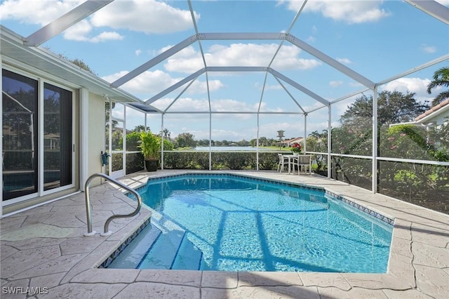 view of swimming pool with glass enclosure and a patio area