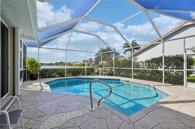 view of pool with a patio area and glass enclosure