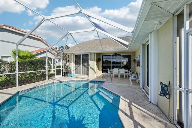 view of pool with a lanai, a patio, and ceiling fan