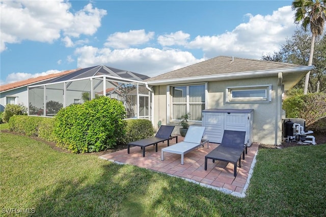 rear view of property with a patio, a yard, and glass enclosure