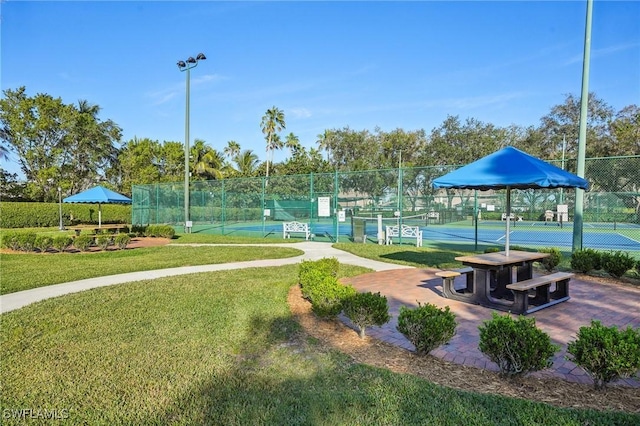 view of property's community featuring a gazebo, a yard, and tennis court