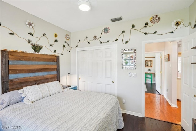 bedroom featuring dark hardwood / wood-style flooring and a closet