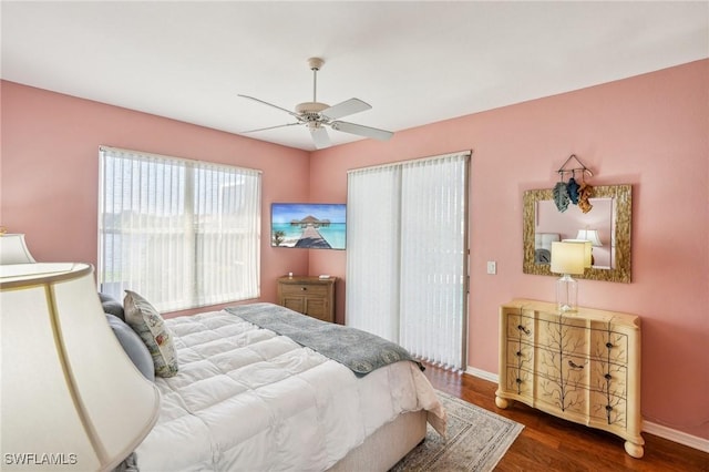 bedroom with dark hardwood / wood-style floors and ceiling fan