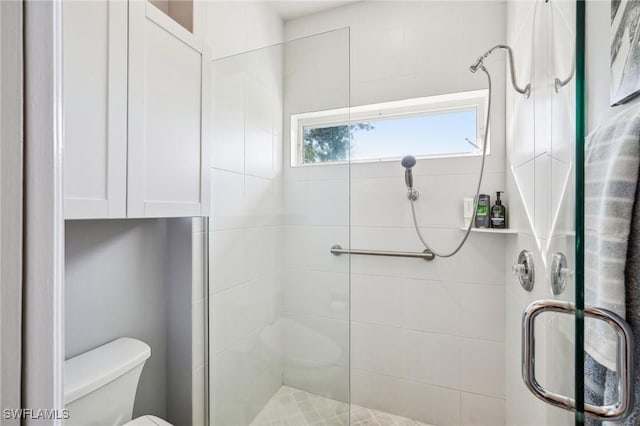 bathroom featuring toilet and walk in shower