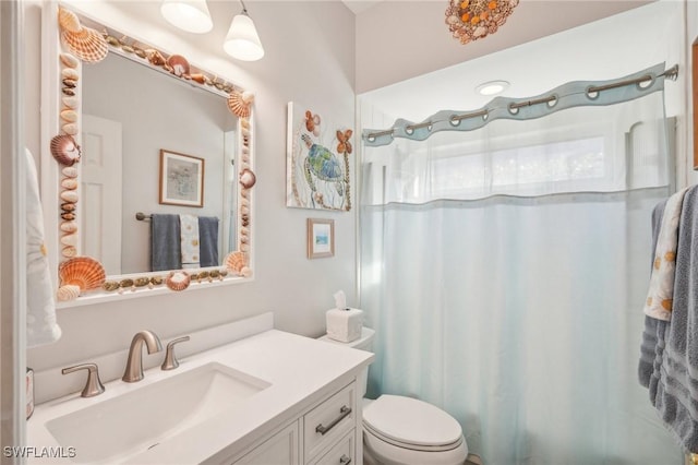 bathroom with vanity, toilet, and curtained shower