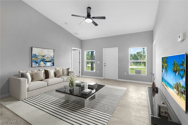 living room with ceiling fan, high vaulted ceiling, and a healthy amount of sunlight