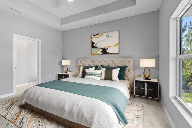 bedroom featuring ceiling fan and a raised ceiling