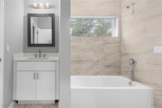 bathroom with vanity and tiled shower / bath combo