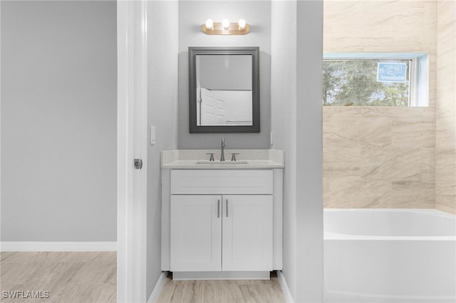 bathroom featuring a tub to relax in and vanity