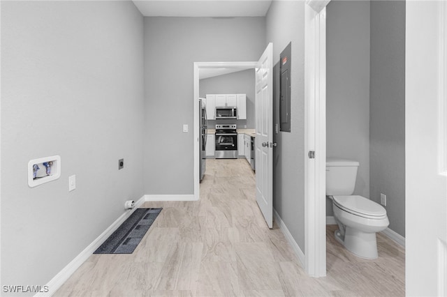 bathroom with toilet and electric panel