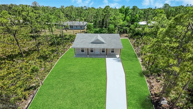 27141 Alhambra Dr, Punta Gorda, FL 33955 - view of front of home featuring a front yard and a wooded view