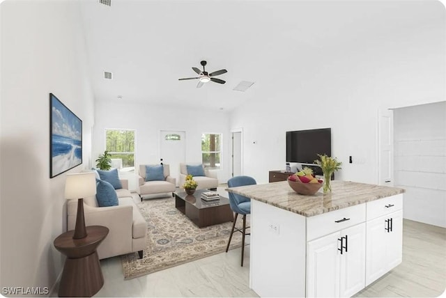 27141 Alhambra Dr, Punta Gorda, FL 33955 - living room with vaulted ceiling, ceiling fan, and light marble finish floors