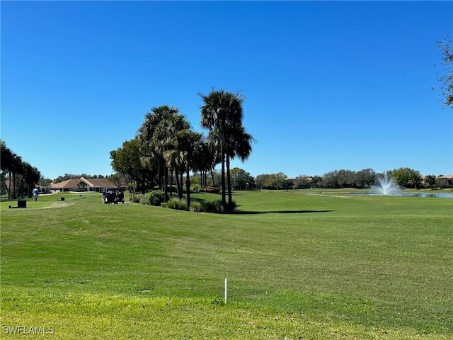 view of home's community featuring a water view and a lawn