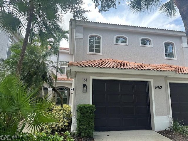 mediterranean / spanish-style home with a garage