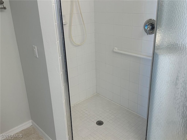 bathroom featuring a shower with door and tile patterned flooring