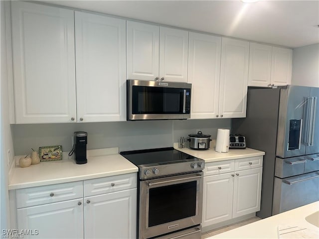 kitchen featuring white cabinetry and appliances with stainless steel finishes