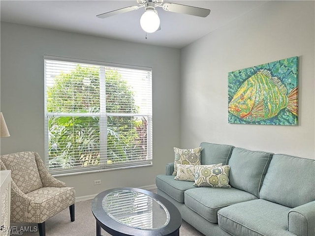 living room with ceiling fan and carpet