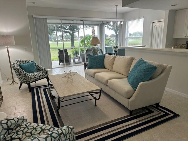 living room featuring light tile patterned floors and a chandelier