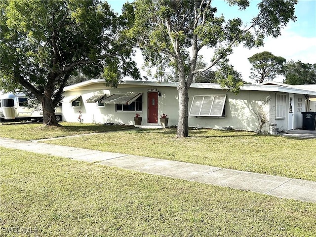 ranch-style home featuring a front yard