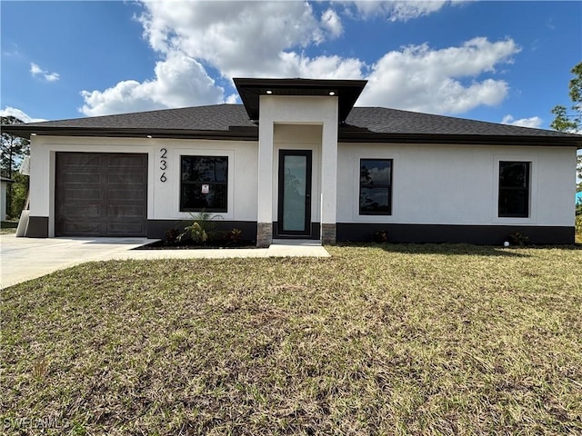 prairie-style house with a garage and a front yard