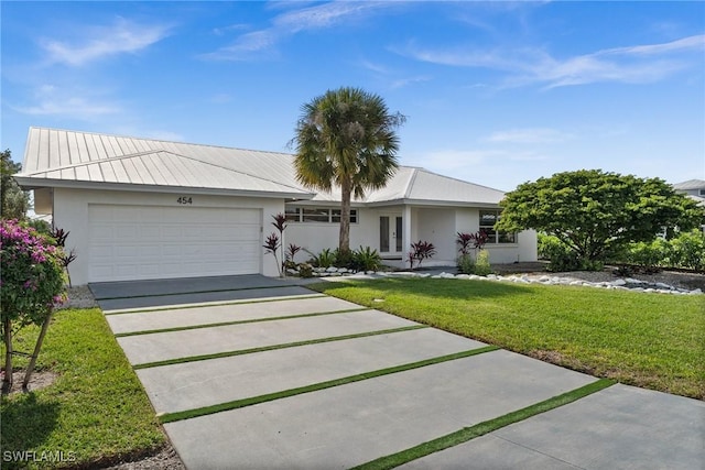 single story home with a garage and a front yard