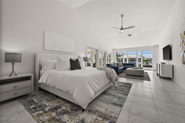 bedroom with ceiling fan and high vaulted ceiling