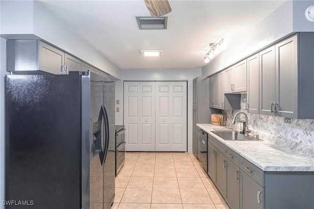 kitchen with sink, stainless steel refrigerator with ice dispenser, gray cabinetry, and dishwasher