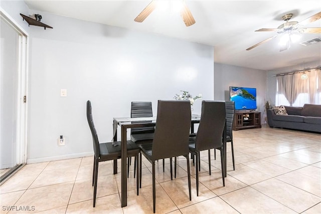 tiled dining area with ceiling fan